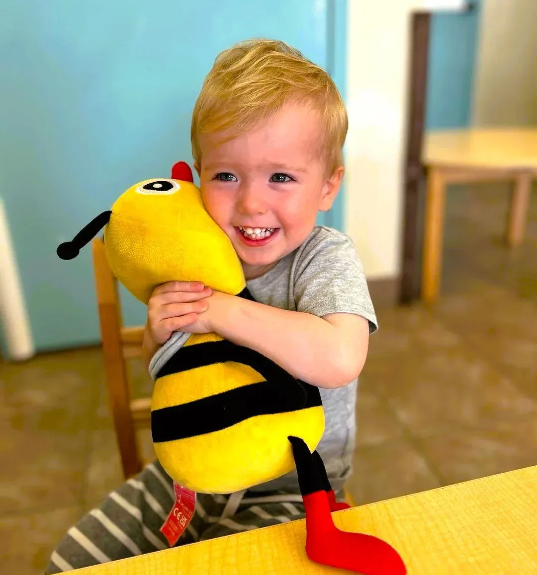 Child holding a polyester plush toy